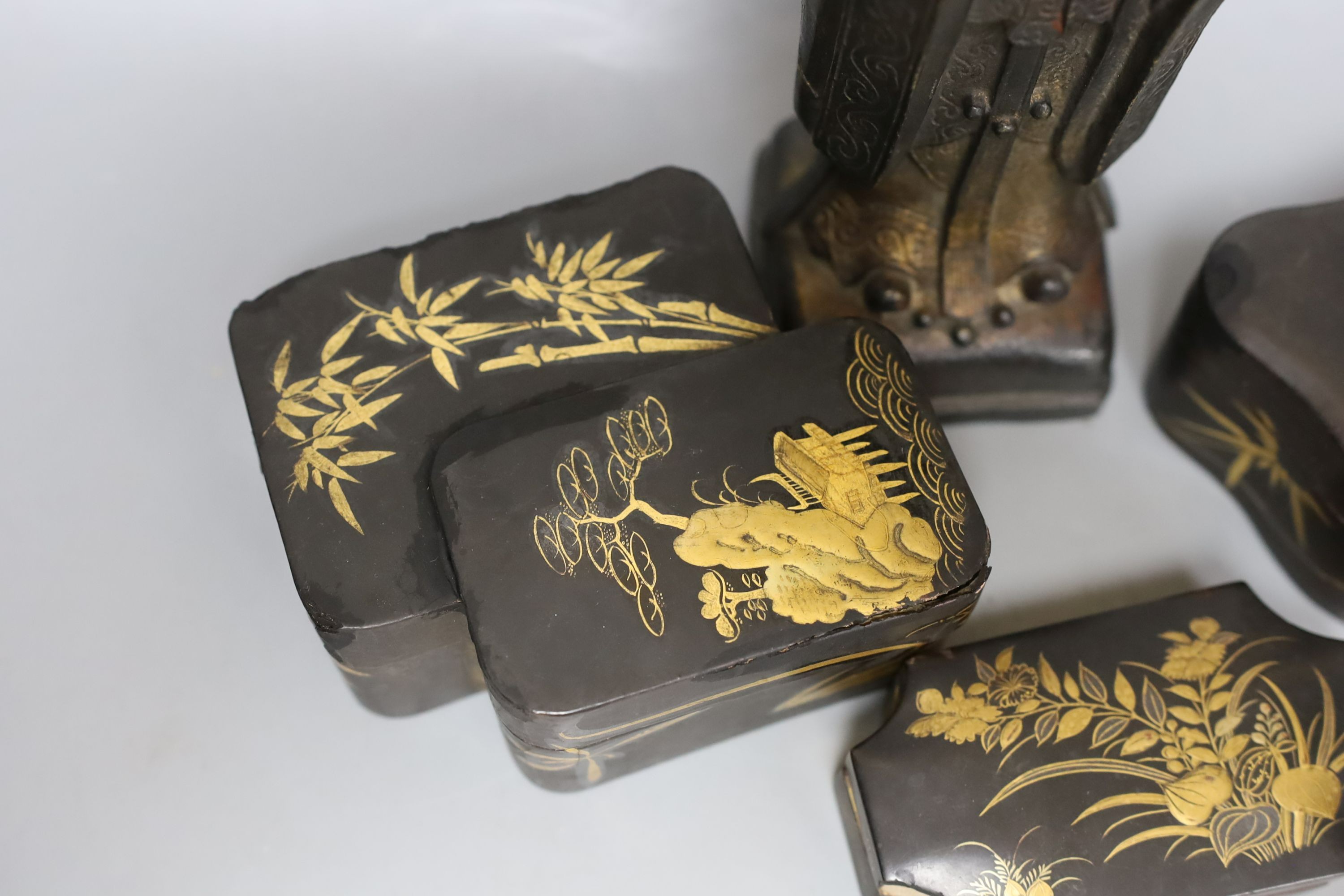 A Chinese bronze figure of an official and three Japanese lacquer boxes. Tallest 29cm